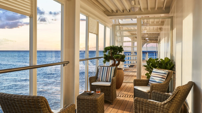 Comfortable seating area on a silversea cruise ship veranda overlooking the open ocean