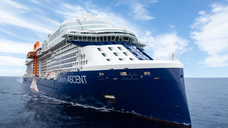 Celebrity Ascent cruise ship sailing across the open ocean under a blue sky