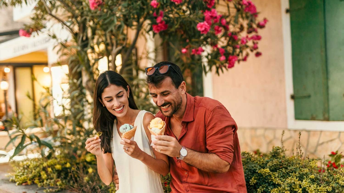 Young couple on vacation enjoying ice cream
