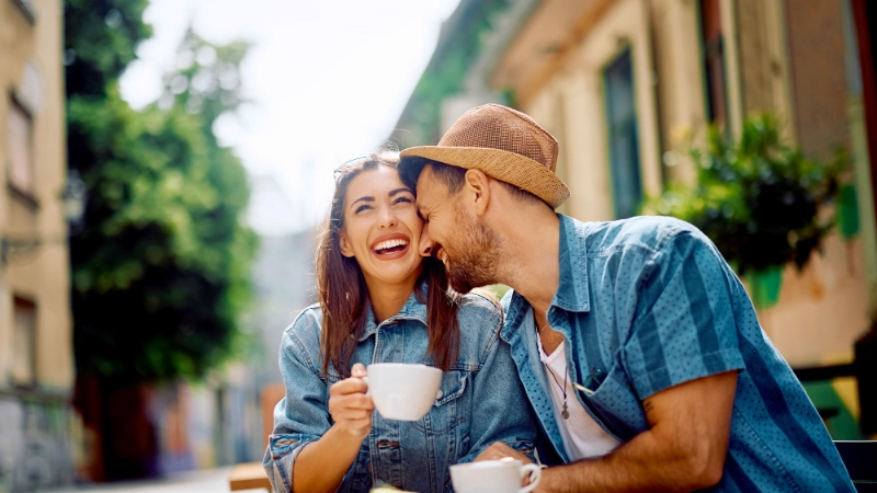 Smiling couple enjoying coffee in europe