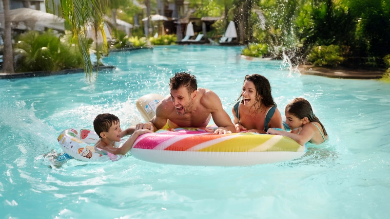 Happy family playing in the pool