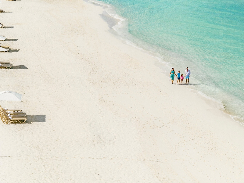 Family walk on beach