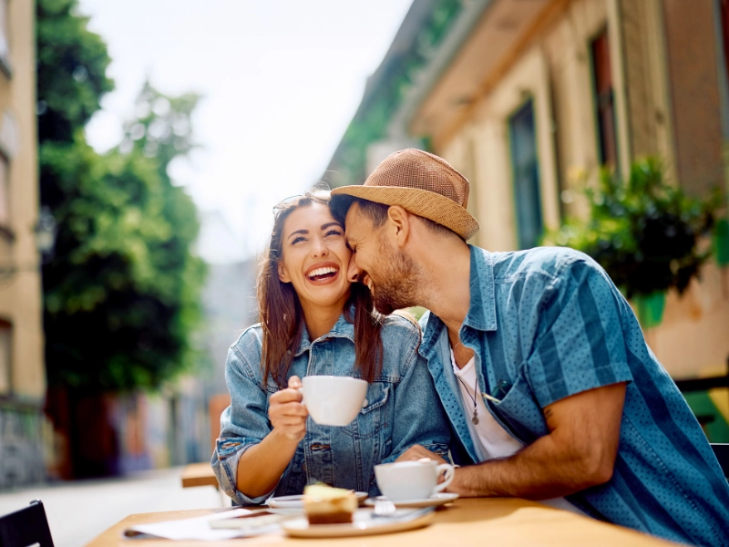 Smiling couple enjoying coffee in europe